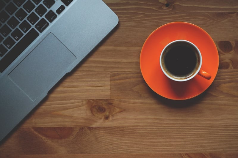 Businessman with laptop and coffee cup